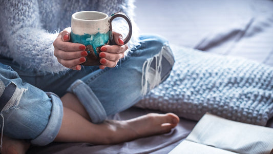 Peaceful bedroom with journal and coffee mug for a stress-free morning