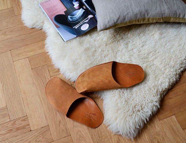 Brown leather CP Slippers home shoes on nice wood floor
