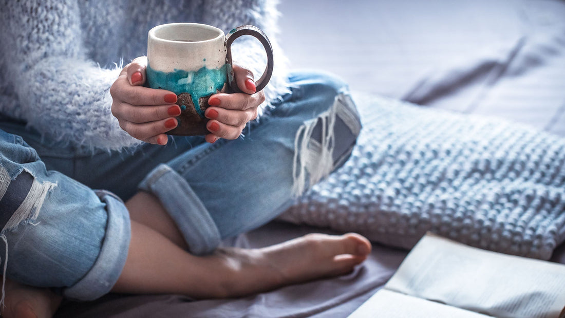 Peaceful bedroom with journal and coffee mug for a stress-free morning