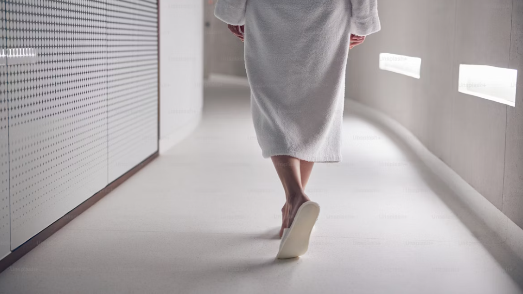 Woman wearing slippers indoors with warm light